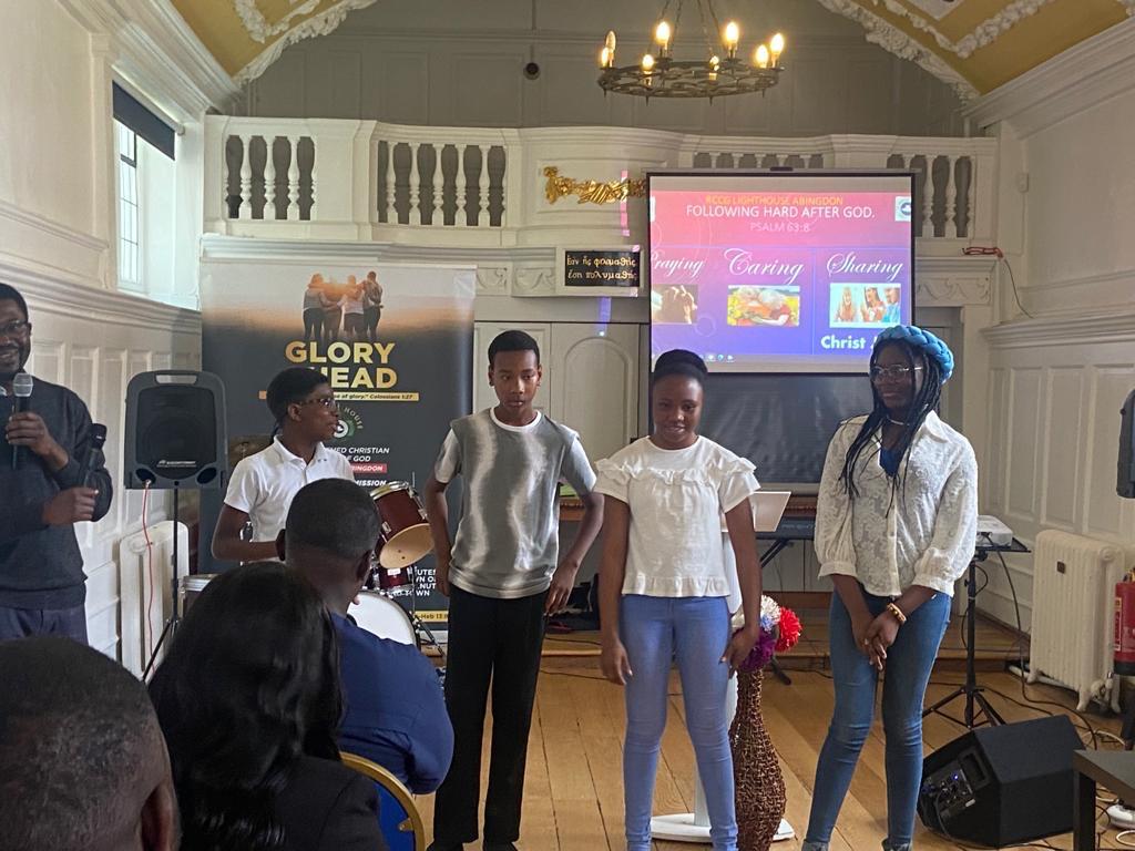 Youth standing at the front during a ministry session