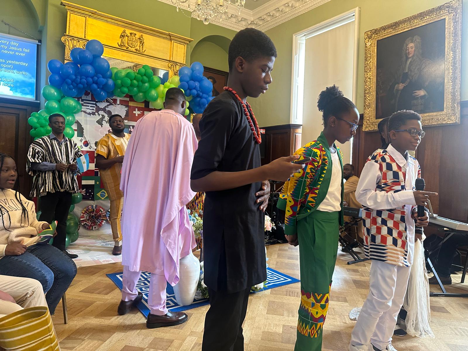 Youth presenting during a colourful church programme