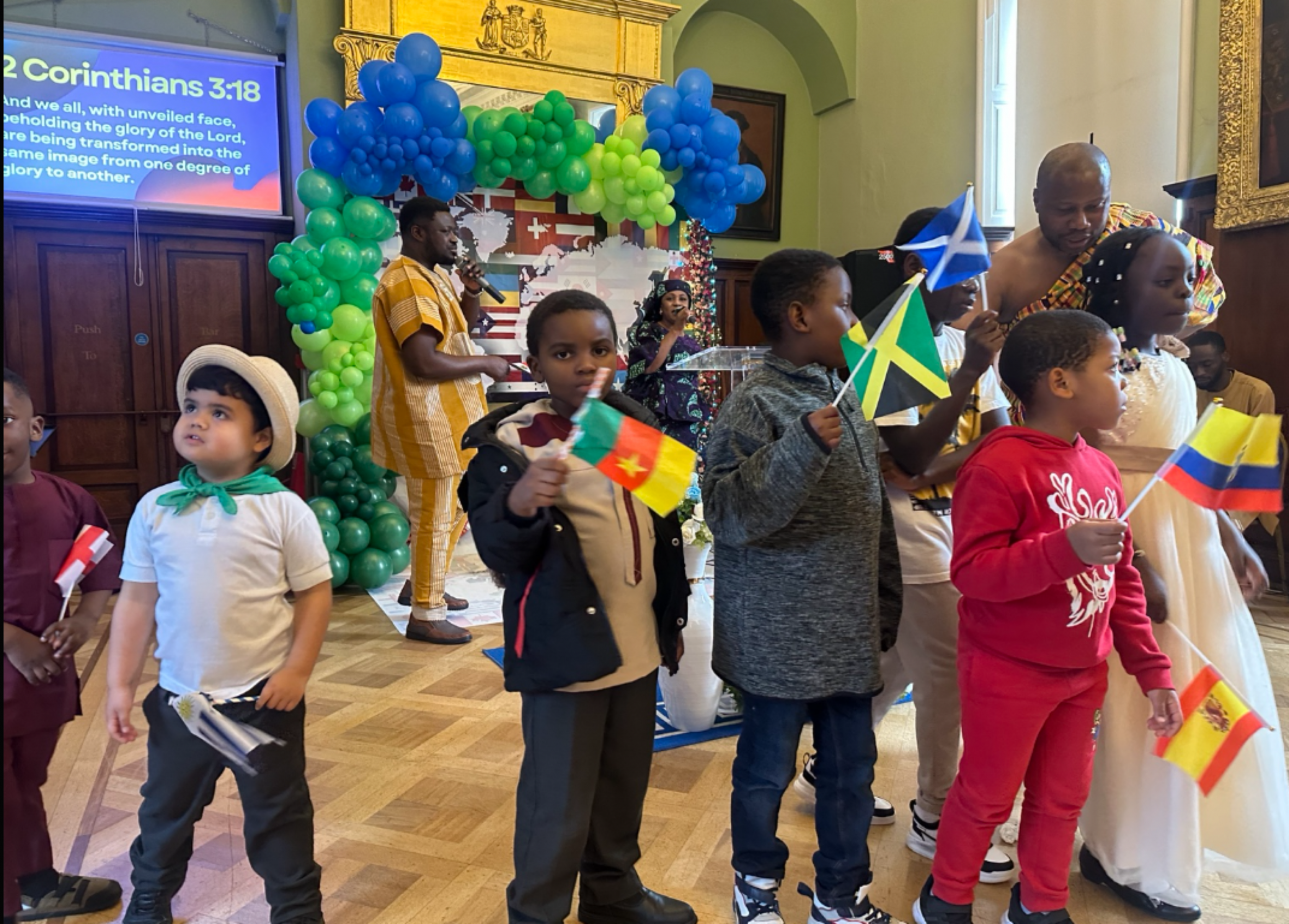 Children holding national flags during a church event